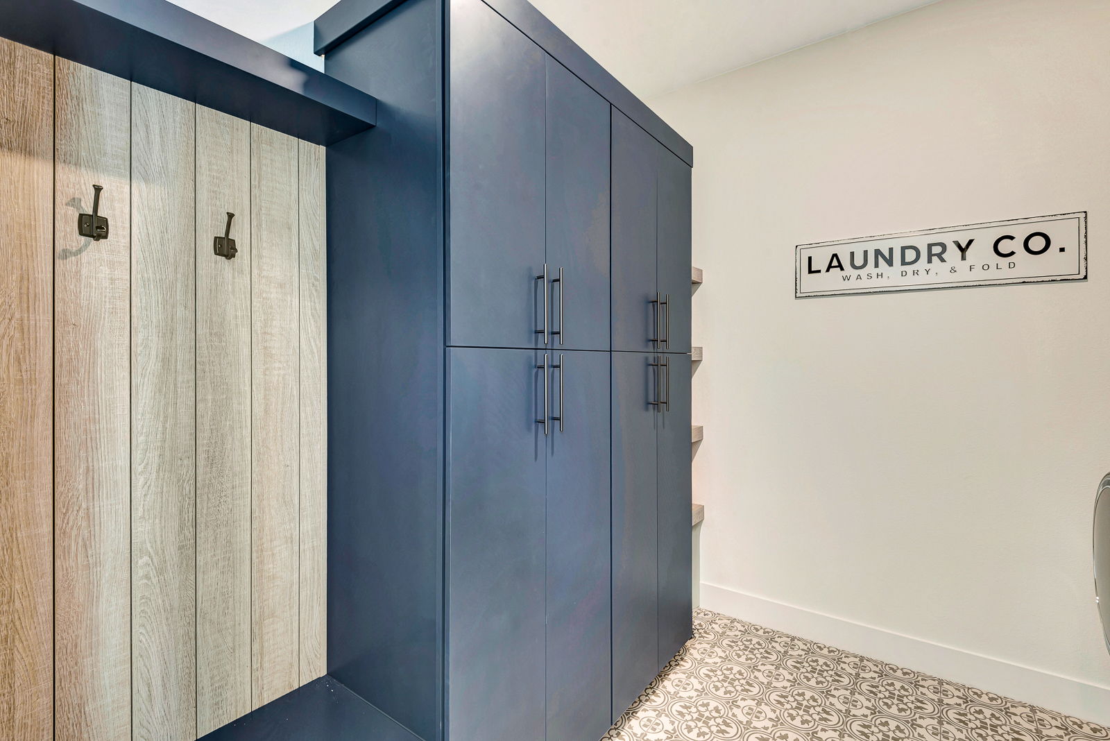 Custom laundry room cabinetry with built-in storage